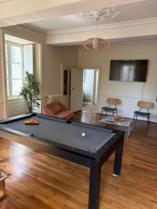 a living room with a pool table in it at Le Durivum in Montaigu-Vendée