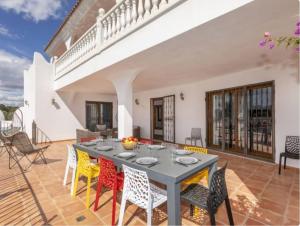 a dining room with a table and chairs on a patio at Finca Azahar in Sant Jordi