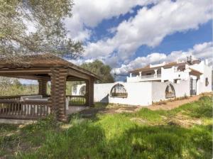 a white house with a pavilion in the yard at Finca Azahar in Sant Jordi