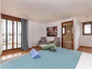 a bedroom with a blue bed and a bathroom at Finca Azahar in Sant Jordi +29 photos