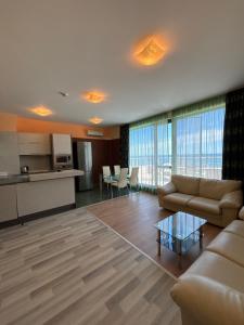 a living room with a couch and a table at IZVORA APART-HOTEL Beach Front Suites in Golden Sands