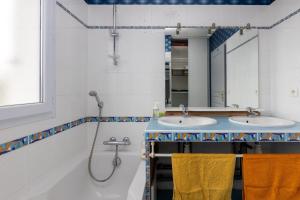 a bathroom with two sinks and a mirror at Belle Maison Basque à Bardos Clim in Bardos +17 photos