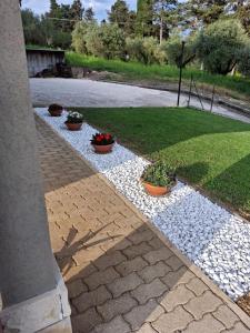 a walkway with three potted plants on it at Casa a Villa in Perugia