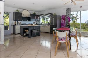 a kitchen with a table and a dining room at Belle Maison Basque à Bardos Clim in Bardos