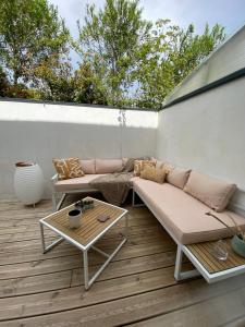 a patio with a couch and a table at Baionako extea in Bayonne