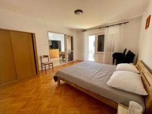 a bedroom with a large bed with pillows on it at Apartments Hrnjić in Umag