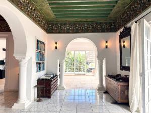an ornate ceiling in a living room with a window at Villa Oasis Hammamet in Hammamet