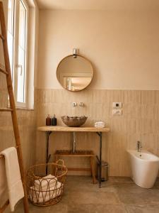 a bathroom with a bowl sink and a mirror at Residenza Villa Genua in Bordighera