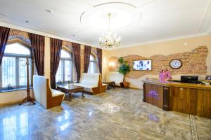 a woman standing at a desk in a lobby at Georgi Hotell in Võru