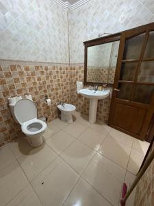a bathroom with a toilet and a sink at Apartment with pool next to the ocean in Agadir nʼ Aït Sa