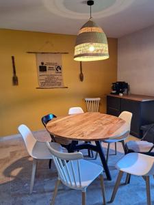 a dining room with a wooden table and chairs at Maquis in Mialet +19 photos