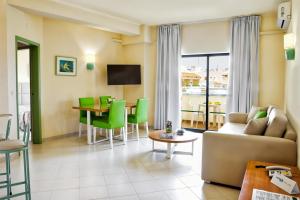 a living room with a couch and a table at Ondamar Hotel Apartamentos in Albufeira