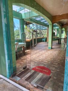 a glass shower in a building with a patio at Ngak-Ngak Beach Resort in Calatrava