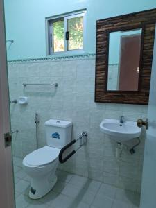a bathroom with a toilet and a sink at Ngak-Ngak Beach Resort in Calatrava