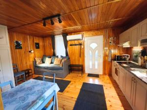 a kitchen and living room with a couch in a room at Igali Kuckó in Igal
