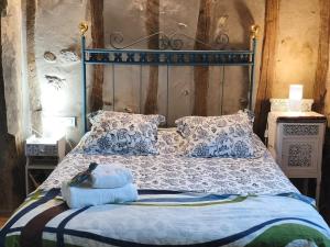 a bed with blue and white sheets and pillows at Casa Sorianna in Montenegro de Cameros