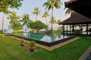 a resort swimming pool with a gazebo and palm trees at Vismaya by Moksha Stays in Turavūr +101 photos