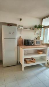 a kitchen with a white refrigerator and a counter at Paradiso Privato di Modolo in Modolo +24 photos