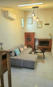 a living room with a couch and a fireplace at Paradiso Privato di Modolo in Modolo
