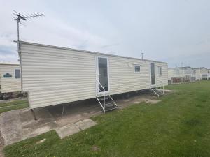 a large white trailer is parked in a yard at S-M Statics in Kinmel Bay