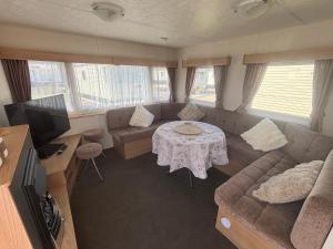 a living room with a couch and a table at S-M Statics in Kinmel Bay