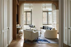 a living room with two chairs and a couch at The St. Regis Budapest in Budapest