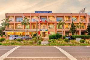 a building with a parking lot in front of it at Hôtel Imi Plage in Agadir +46 photos