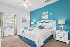a blue bedroom with a bed and a ceiling fan at Orlando Theme Park Pool Homes in Kissimmee +154 photos