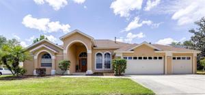 a large house with a garage at Orlando Theme Park Pool Homes in Kissimmee