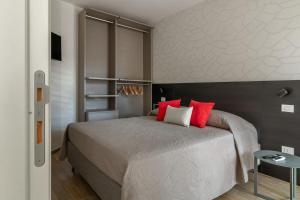 a bedroom with a large bed with red pillows at Palladio13 in San Benedetto del Tronto