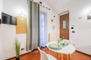 a white dining room with a white table and chairs at Evergreen House in Cuneo +39 photos