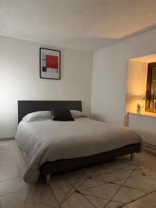 a bedroom with a bed in a white room at Mountain Getaway Panoramic View - Pets Welcome in Gromo