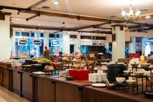 a buffet line in a restaurant with a lot of food at Movenpick Suriwongse Hotel Chiang Mai in Chiang Mai