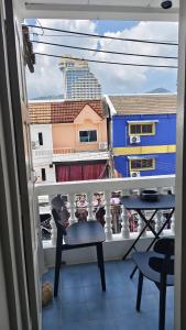 a balcony with a chair and a view of a building at jdreamboxhostelpatong in Patong Beach