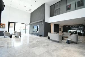 a lobby with chairs and tables in a building at Dorana Hotel Gazimagusa in Famagusta