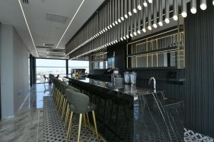 a restaurant with a long bar with stools at Dorana Hotel Gazimagusa in Famagusta +15 photos
