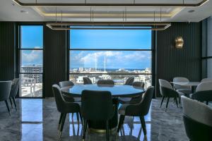 a conference room with a table and chairs and a large window at Dorana Hotel Gazimagusa in Famagusta