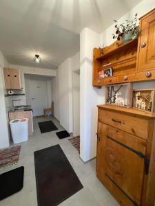a kitchen with a large wooden cabinet in a room at Haus Friedau in Ellmau