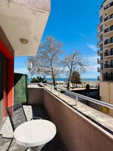 a balcony with a table and a view of the ocean at IZVORA APART-HOTEL Beach Front Suites in Golden Sands