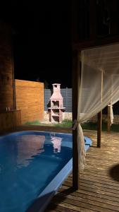 a pool with a canopy next to a wooden deck at Villa Maris in Demre