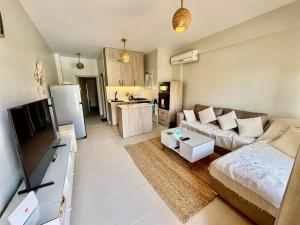a living room with a couch and a kitchen at Poolfront Sea View Chalet Top Rated In Dahab in Dahab