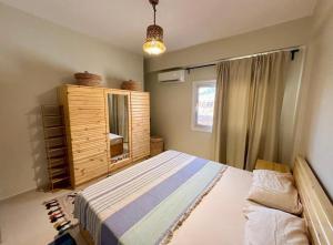 a bedroom with a bed and a cabinet and a window at Poolfront Sea View Chalet Top Rated In Dahab in Dahab +35 photos