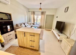 a large living room with a couch and a tv at Poolfront Sea View Chalet Top Rated In Dahab in Dahab
