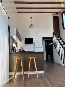a kitchen with two stools and a counter top at Villa Maris in Demre +1 photo
