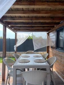 a white table and chairs on a wooden deck at Villa Maris in Demre