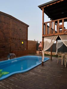 a swimming pool on a deck next to a house at Villa Maris in Demre