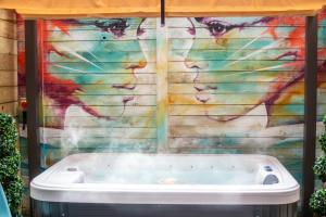 a bath tub in front of a wall with a painting at Duke Street Boutique Hotel in Liverpool +66 photos