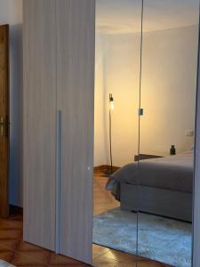 a bedroom with a bed and a glass wall at Mountain Getaway Panoramic View - Pets Welcome in Gromo +4 photos