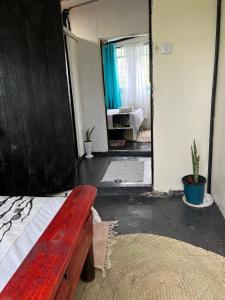 a bedroom with a wooden bed and a mirror at D's FarmStay in Kajiado +15 photos