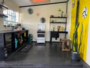a kitchen with a stove and a refrigerator at D's FarmStay in Kajiado